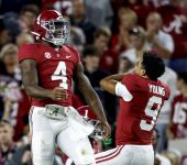 Alabama Crimson Tide quarterback Jalen Milroe (4) celebrates with quarterback Bryce Young (9) after throwing a touchdown pass against the Texas A&M Aggies during the first half at Bryant-Denny Stadium.