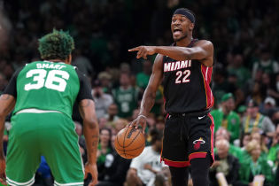 Miami Heat forward Jimmy Butler (22) controls the ball against Boston Celtics guard Marcus Smart (36) in the first quarter during game seven of the Eastern Conference Finals for the 2023 NBA playoffs at TD Garden.
