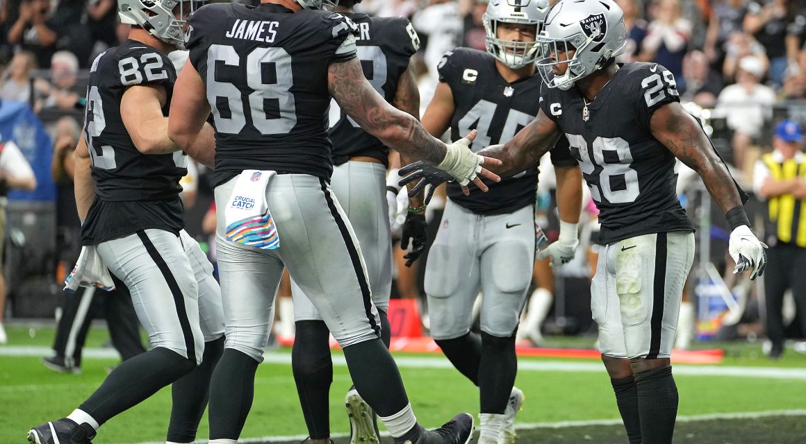Raiders RB Josh Jacobs (28) is congratulated by Las Vegas Raiders center Andre James (68) after scoring a touchdown against the Chicago Bears. / Stephen R. Sylvanie-USA TODAY Sports