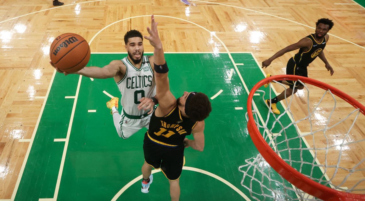 Boston Celtics forward Jayson Tatum (0) attempts a layup past Golden State Warriors guard Klay Thompson (11) during the first quarter of game four in the 2022 NBA Finals at the TD Garden. Mandatory Credit: Elsa/Pool Photo-USA TODAY Sports.