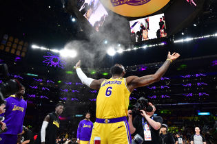 Los Angeles Lakers forward LeBron James (6) tosses up powder before playing against the Minnesota Timberwolves at Crypto.com Arena.
