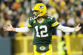 Dec 12, 2021; Green Bay, Wisconsin, USA; Green Bay Packers quarterback Aaron Rodgers (12) reacts after throwing a touchdown pass during the third quarter against the Chicago Bears at Lambeau Field. Mandatory Credit: Jeff Hanisch-USA TODAY Sports