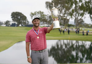 Jon Rahm celebrates with the trophy after winning he U.S. Open golf tournament at Torrey Pines Golf Course. Mandatory Credit: Michael Madrid-USA TODAY Sports.