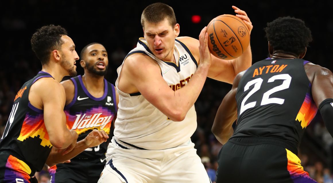 Nuggets center Nikola Jokic (15) drives to the basket against the Phoenix Suns in the second half at Footprint Center. / Mark J. Rebilas-USA TODAY Sports