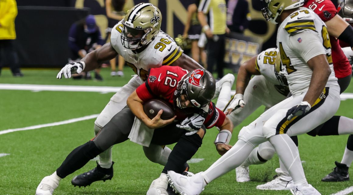 Oct 31, 2021; New Orleans, LA; Tampa Bay Buccaneers quarterback Tom Brady (12) is sacked by New Orleans Saints defensive end Tanoh Kpassagnon (90). / © Stephen Lew-USA TODAY Sports