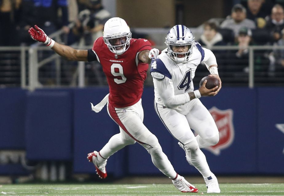 Dallas Cowboys quarterback Dak Prescott (4) scrambles before