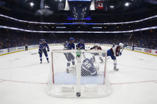 Colorado Avalanche center Nazem Kadri (91) scores the game-winning goal on Tampa Bay Lightning goaltender Andrei Vasilevskiy (88) in overtime in game four of the 2022 Stanley Cup Final at Amalie Arena. Mandatory Credit: Geoff Burke-USA TODAY Sports.