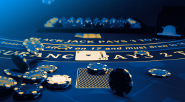 Image of a blackjack table with chips and cards