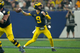 Michigan Wolverines quarterback J.J. McCarthy (9) makes a throw against the TCU Horned Frogs in the first half of the 2022 Fiesta Bowl at State Farm Stadium.