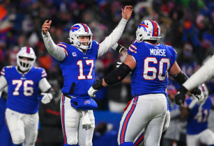 Buffalo Bills quarterback Josh Allen (17) celebrates a touchdown pass with center Mitch Morse (60) during the third quarter of the AFC Wild Card playoff game against the New England Patriots at Highmark Stadium. Mandatory Credit: Rich Barnes-USA TODAY Sports.