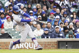 Los Angeles Dodgers shortstop Mookie Betts (50) hits a two-run double against the Chicago Cubs during the ninth inning at Wrigley Field.