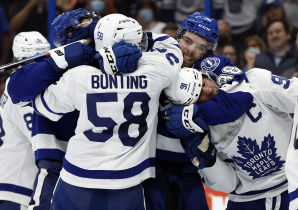 oronto Maple Leafs center John Tavares (91), left wing Michael Bunting (58), Tampa Bay Lightning left wing Brandon Hagel (38) and teammates fight during the second period at Amalie Arena. Mandatory Credit: Kim Klement-USA TODAY Sports.