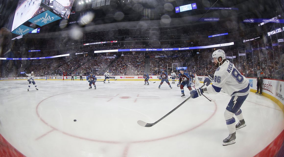 Tampa Bay Lightning right wing Nikita Kucherov (86) clears the puck against the Colorado Avalanche during the third period in game two of the 2022 Stanley Cup Final at Ball Arena. Mandatory Credit: Isaiah J. Downing-USA TODAY Sports.