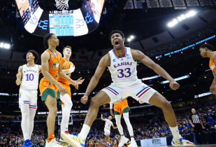 Kansas Jayhawks forward David McCormack (33) reacts after a play during the second half against the Miami Hurricanes in the finals of the Midwest regional of the men's college basketball NCAA Tournament at United Center. Mandatory Credit: David Banks-USA TODAY Sports.