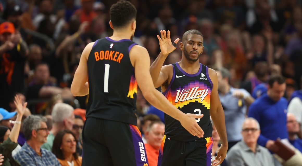 Phoenix Suns guard Devin Booker (1) and guard Chris Paul (3) celebrate the victory against the Philadelphia 76ers at Footprint Center. Mandatory Credit: Mark J. Rebilas-USA TODAY Sports.