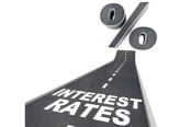 The words Interest Rates on a blacktop road and a percent sign