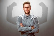 Smiling Businessman with muscular shadow arms