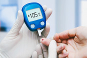 Doctor making blood sugar test in clinic for diabetes