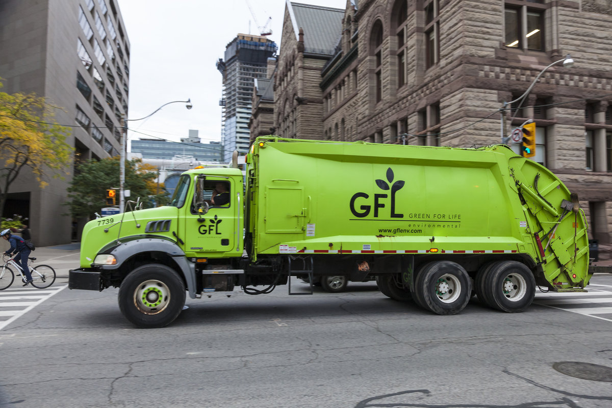 Green GFL environmental service truck in the city of Toronto, Canada