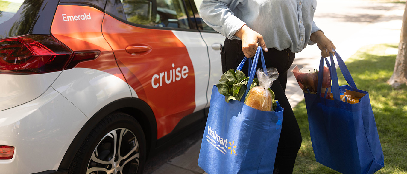 Woman carrying her Walmart bags away from Cruise driverless car