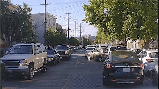 Clip fo a Cruise AV encountering and navigating multiple double-parked vehicles