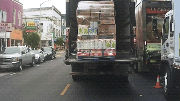 After yielding to the cyclist, we see an oncoming vehicle allowing us to complete our maneuver around the double-parked truck. It is important to recognize these situations and complete the maneuver so we support traffic flow.