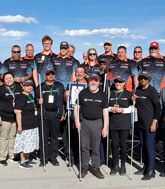 Members of the National Federation of the Blind standing together with their canes