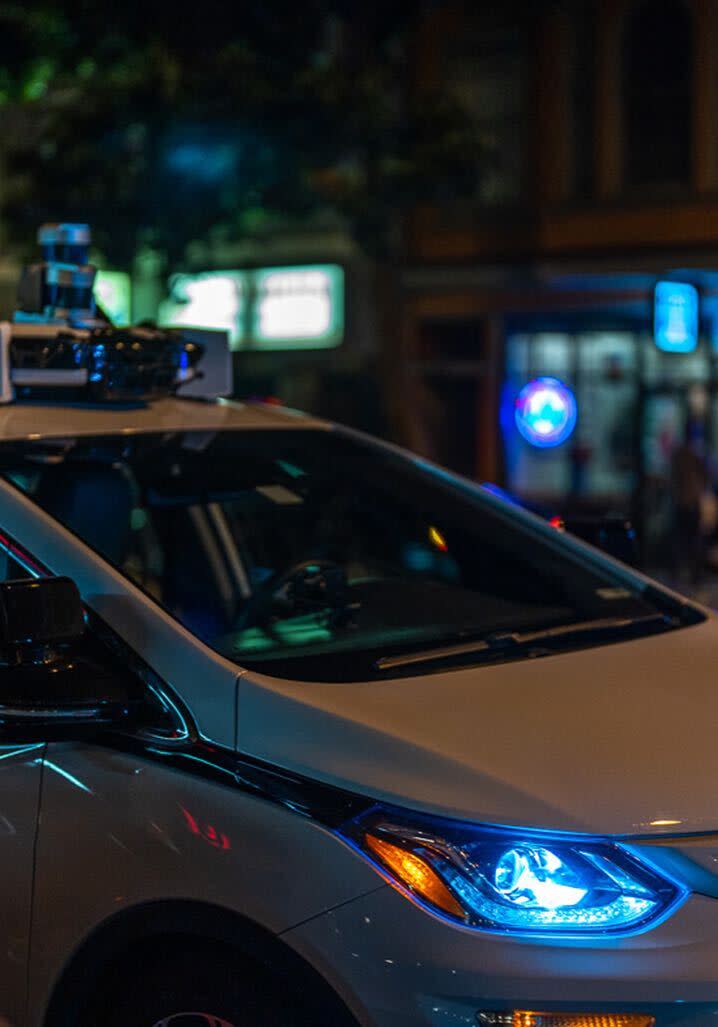 Partial view of Cruise driverless car on the street at night
