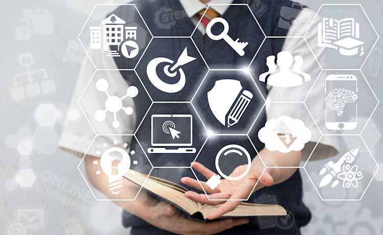 Students engaging with digital devices in a modern classroom, representing the evolution of education in the digital era. Students engaging with digital devices in a modern classroom, representing the evolution of education in the digital era.