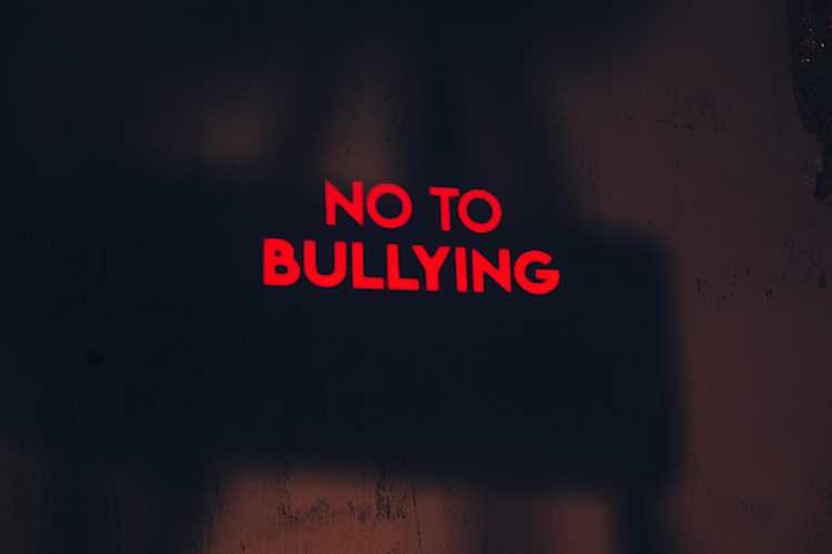 Red 'say no to bullying' sign on black background Red 'say no to bullying' sign on black background