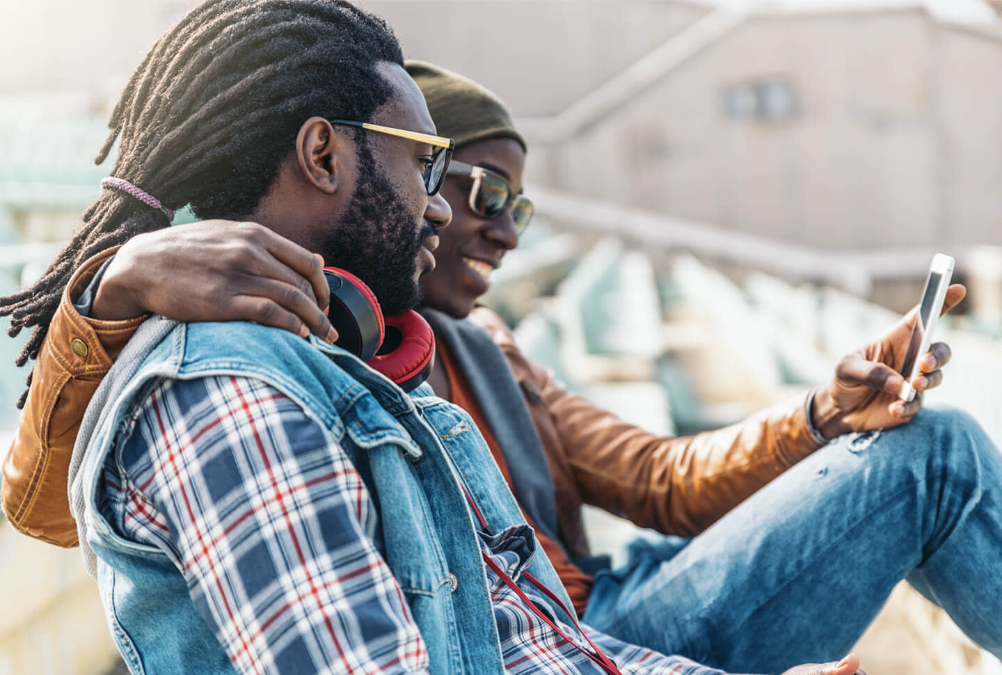 Black man with dreads hanging with friend looking at phone Black man with dreads hanging with friend looking at phone
