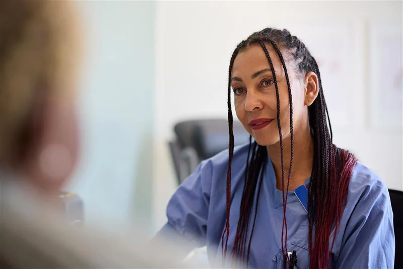 Doctor sitting in office talking to patient