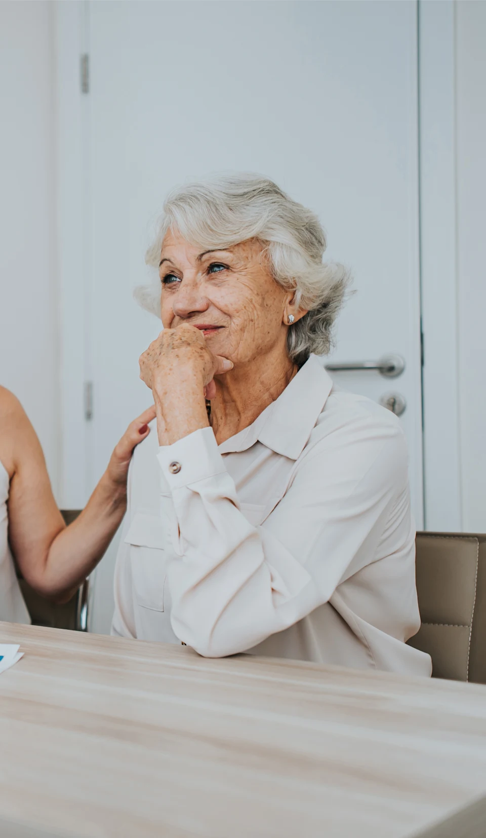 Older woman sitting with daughter in doctor office