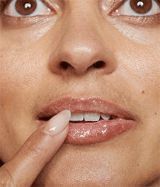 woman putting on lip cream