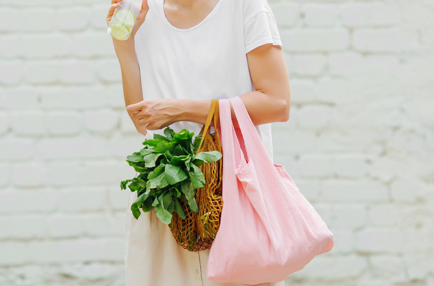 woman carrying bags of vegetables