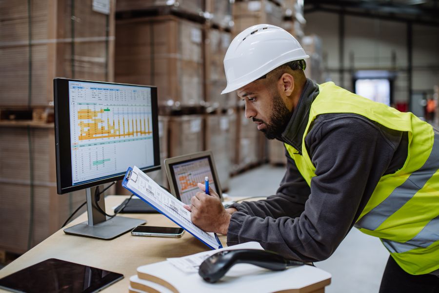 warehouse manager reviewing data gathered from the inventory management system