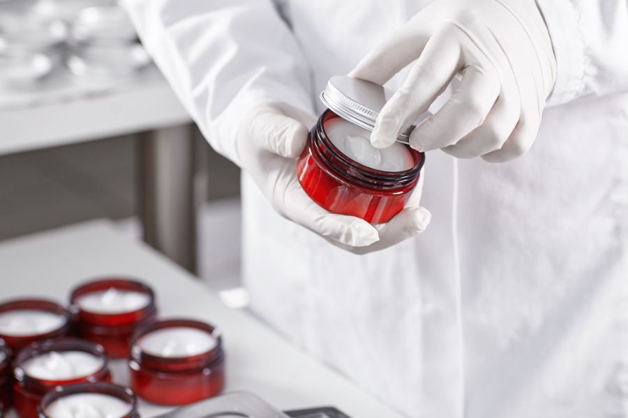 chemical specialist tests jars of product for chemical interactions