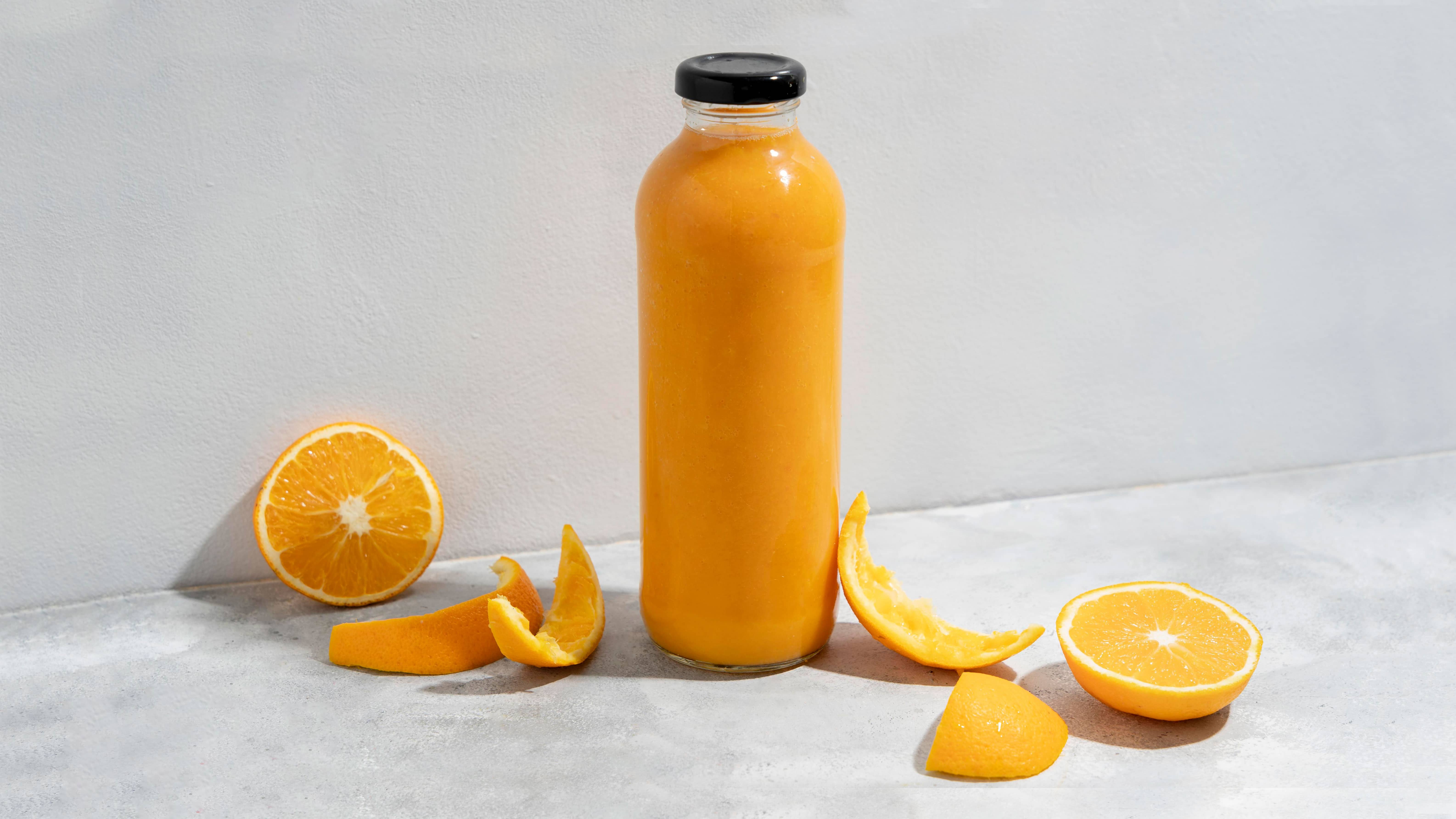 orange juice in glass bottle with lid