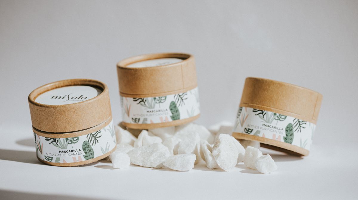 paper canisters with simple botanical design branding elements.