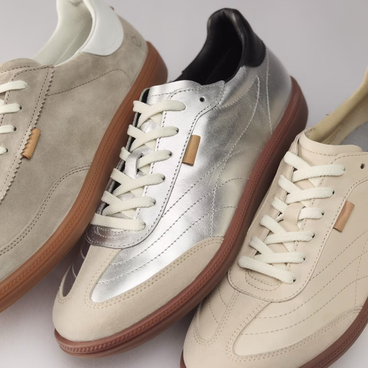 Eine kuratierte Auswahl an flachen Freizeitsneakern, die ECCOs Lederhandwerkskunst präsentieren – von edlem Wildleder bis hin zu auffälligen Metallic-Finishes.