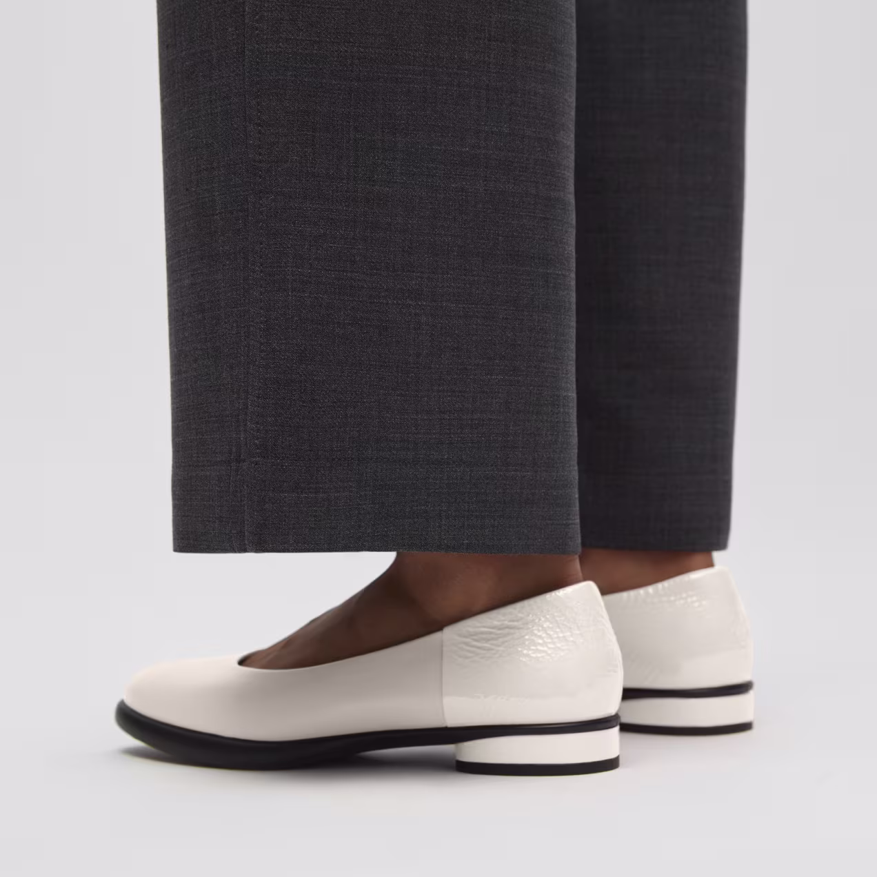 Clean lines define modern sophistication. Crafted from rich white leather, these minimalist flats offer an innovative, lightweight feel for all-day wear.