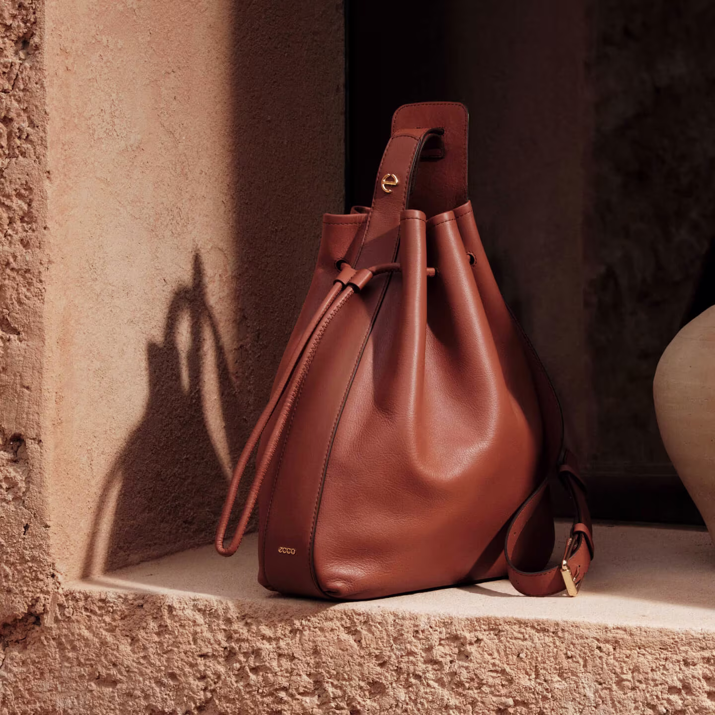 ECCO Sail Bag M, Leather Hobo Bag photographed on a rocky enviroment.