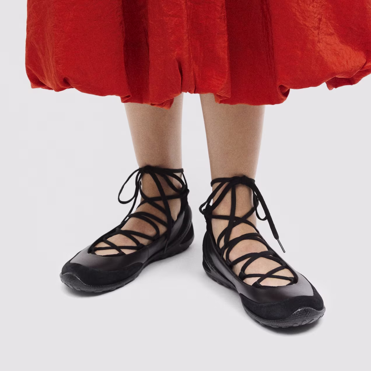 Make a statement in comfort. Premium black leather and intricate lace-up detailing deliver an exquisite fit that moves naturally with you.
