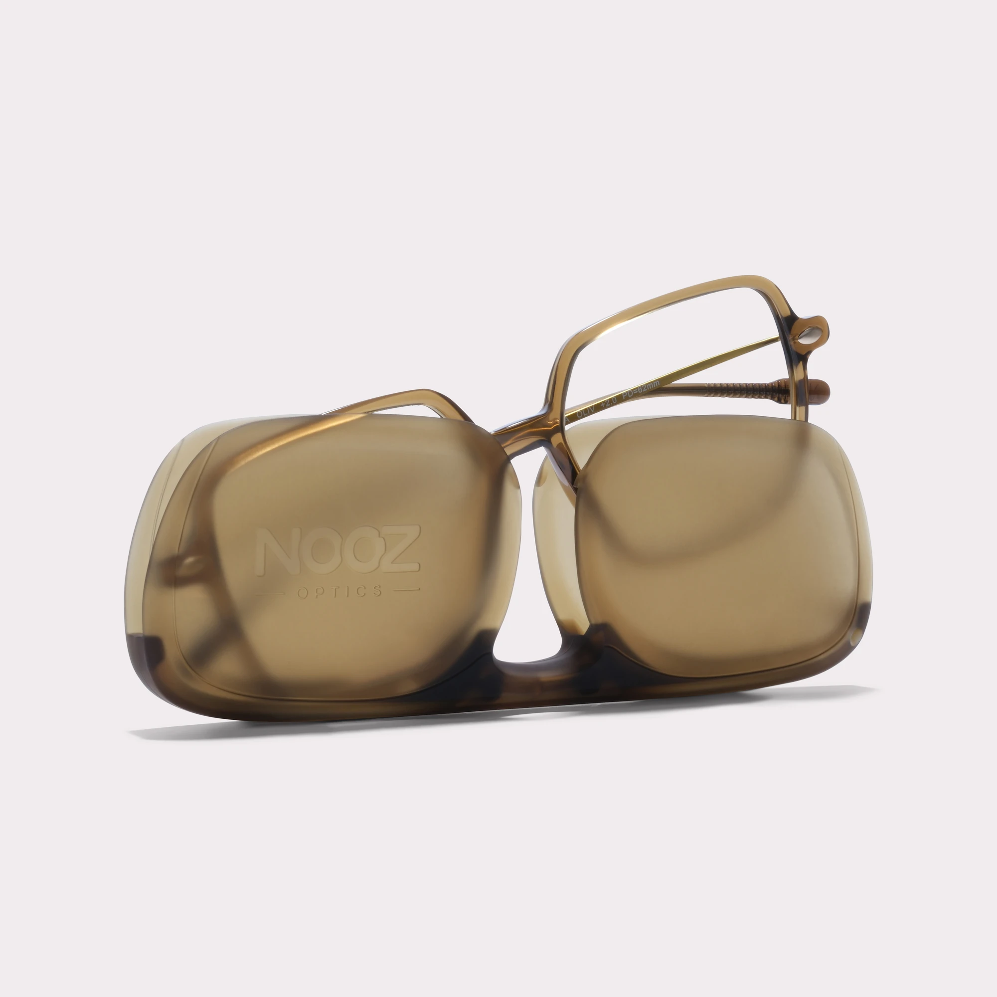 A pair of Lena Olive Reading glasses coming out of its case