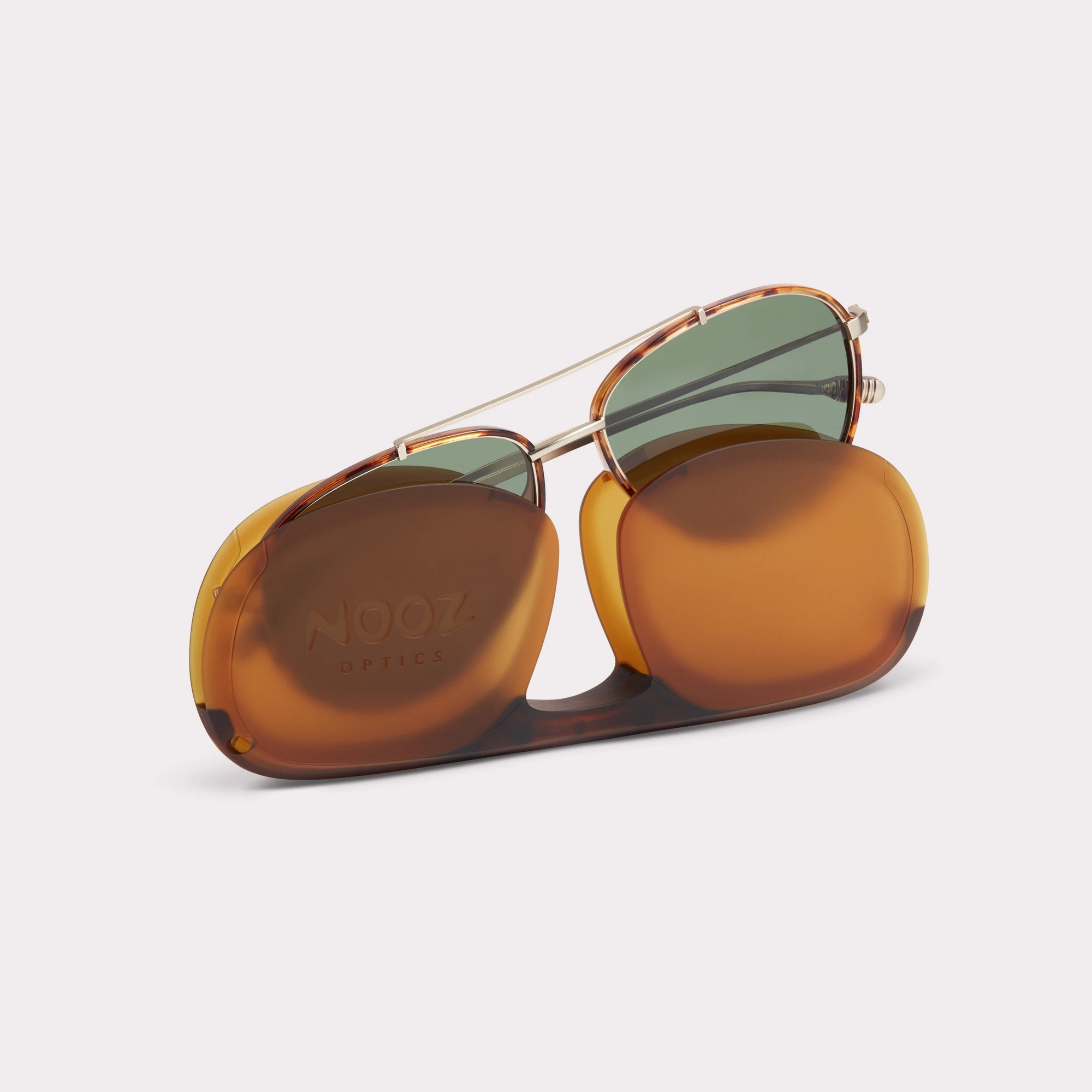 A pair of Jet Tortoise Sunglasses coming out of its case