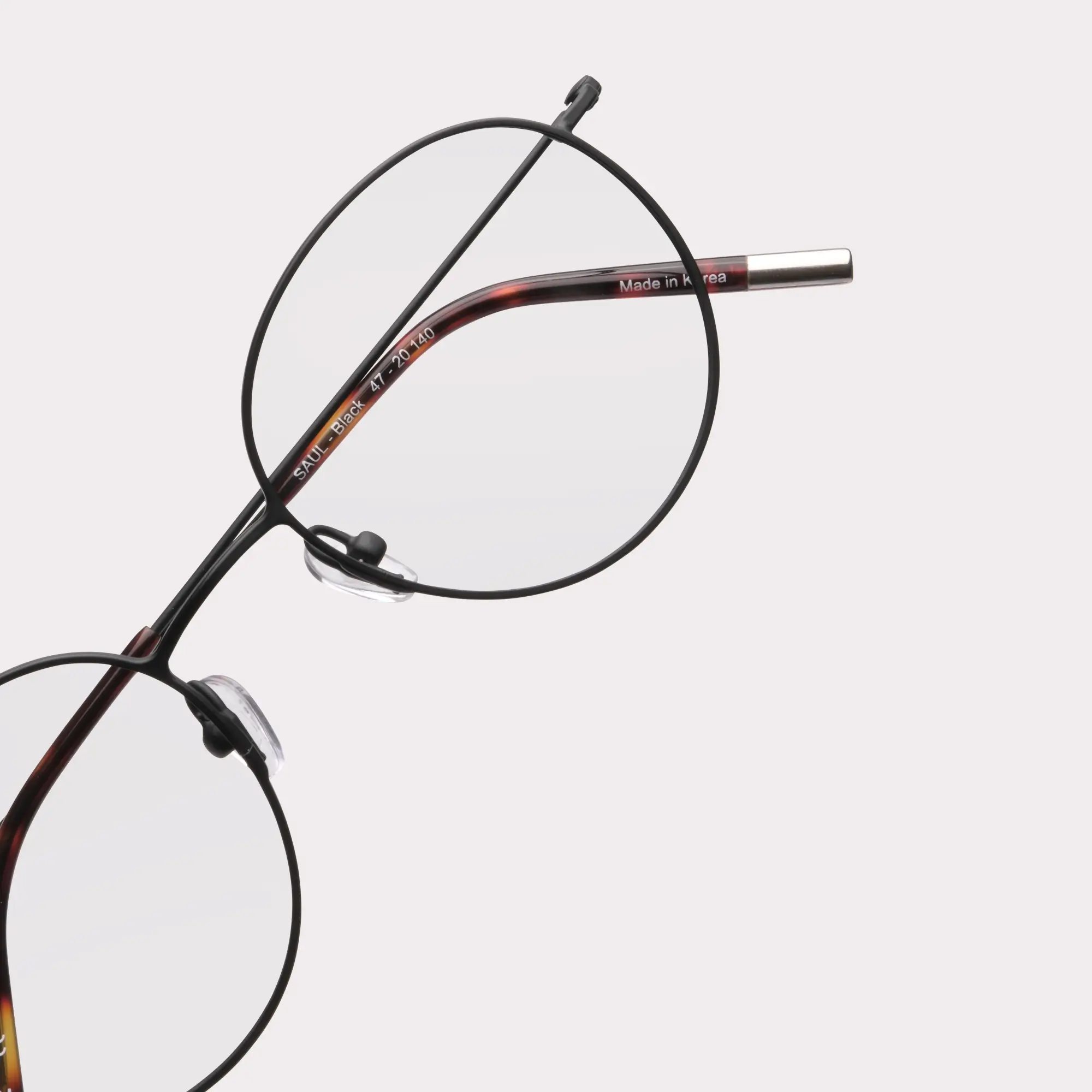 A pair of Saul Black Multi-distance™ blue light blocking reading glasses in a macro view