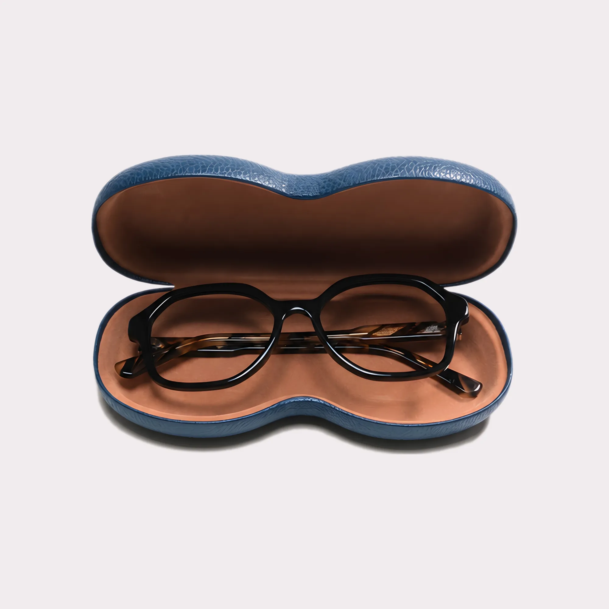 A pair of Aura Black Reading glasses coming out of its case