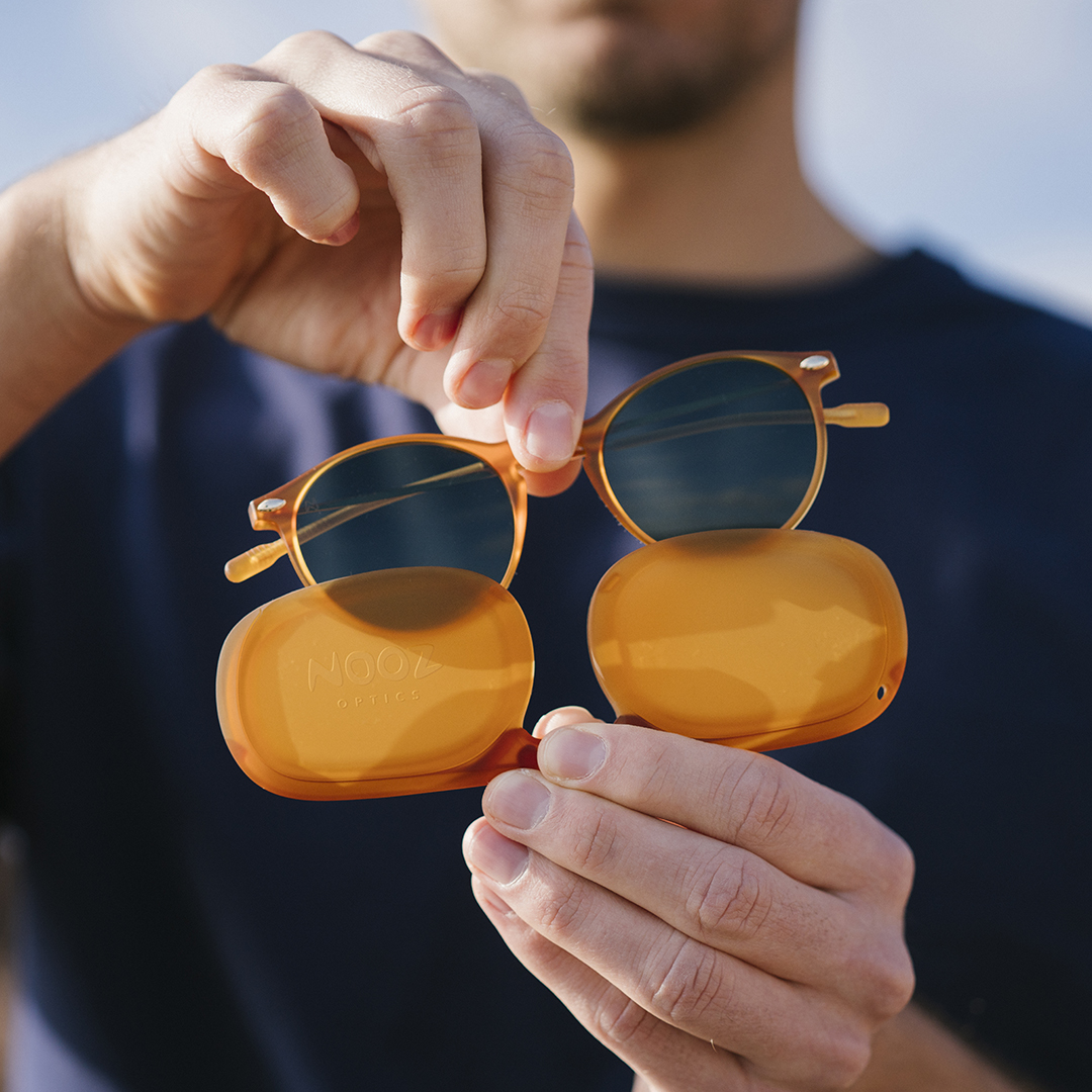 Child sunglasses worn by two children with their mother