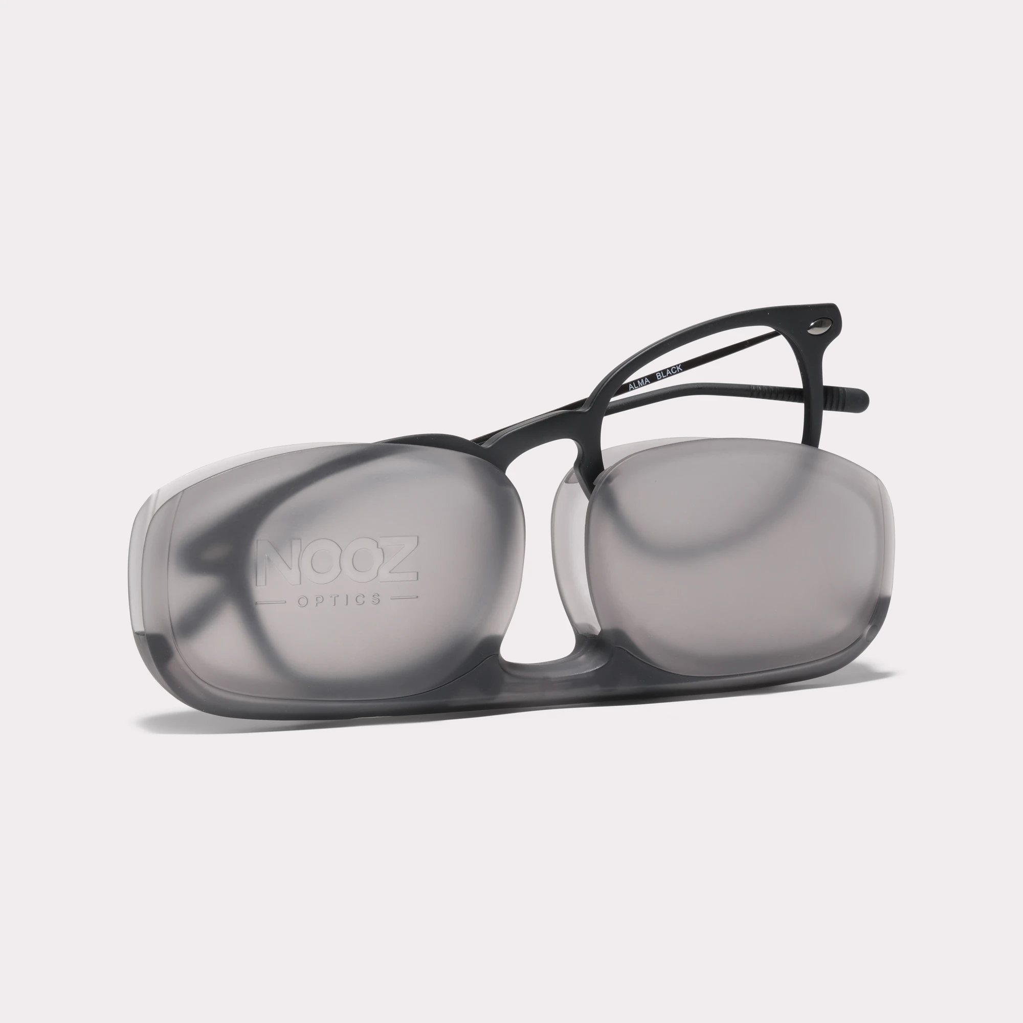 A pair of Alma Black Reading glasses coming out of its case