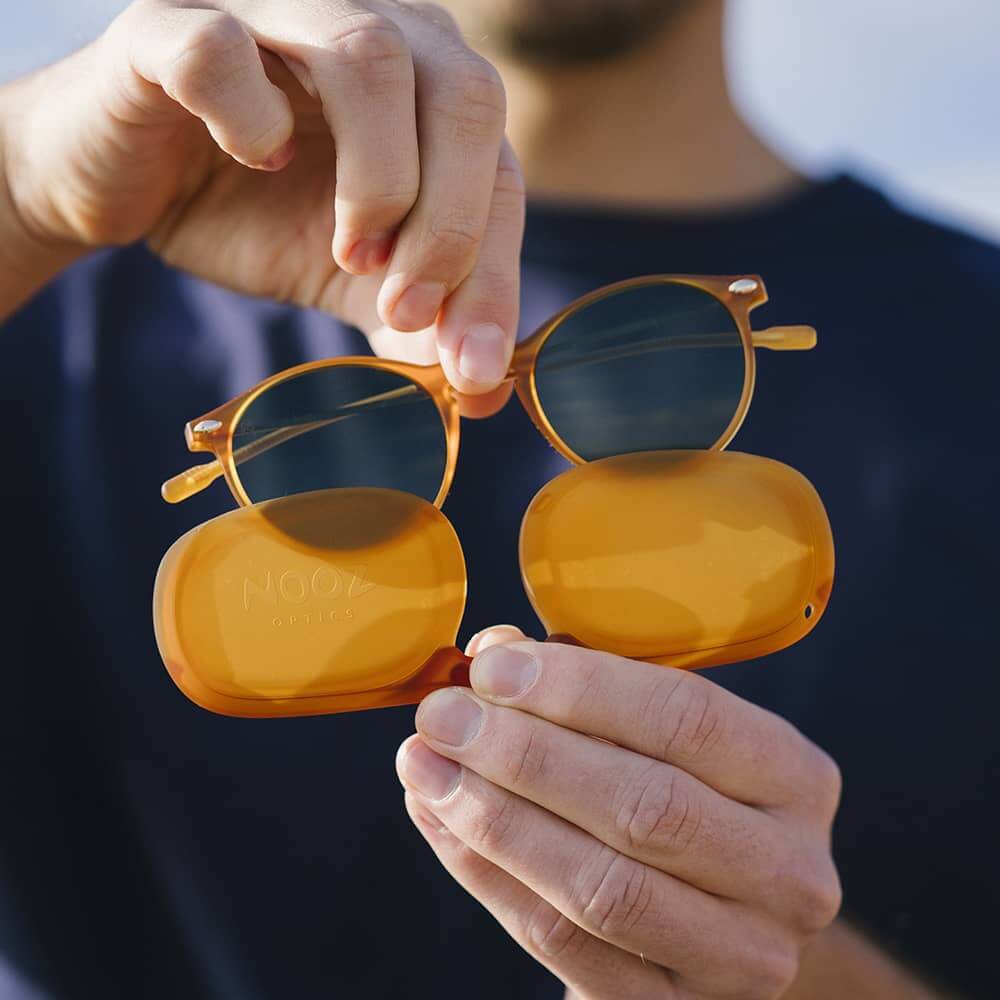 Pair of sunglasses out of their transportation case by man